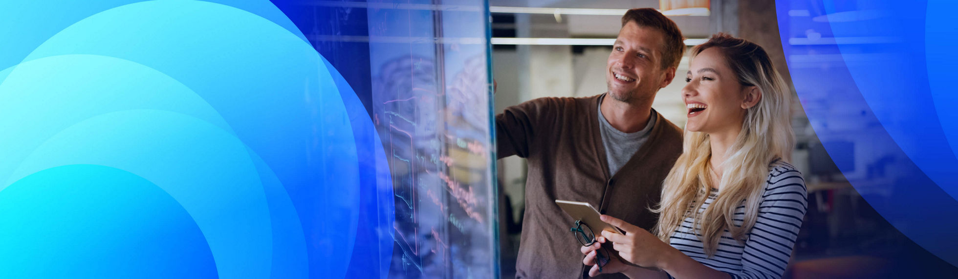 Two professionals brainstorming together holding a tablet