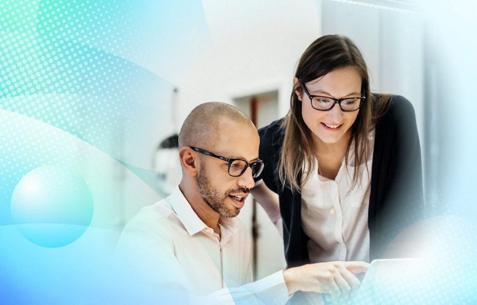 Man and woman collaborating while looking at screen