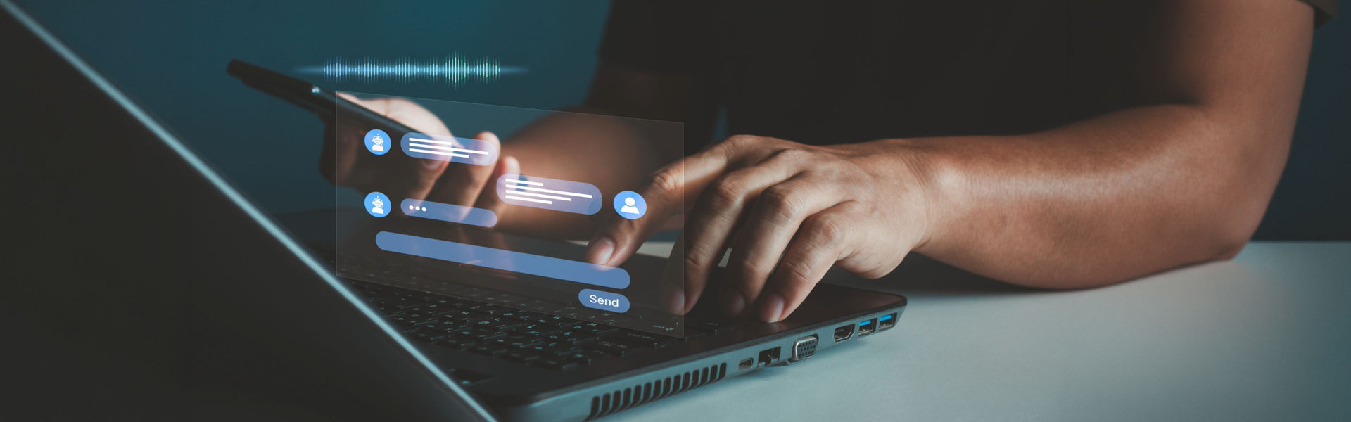 Person using laptop and phone at the same time, engaging in conversation with AI chatbot – depicting machine calling and operational planning challenges presented by increasing customer AI literacy for contact centres.