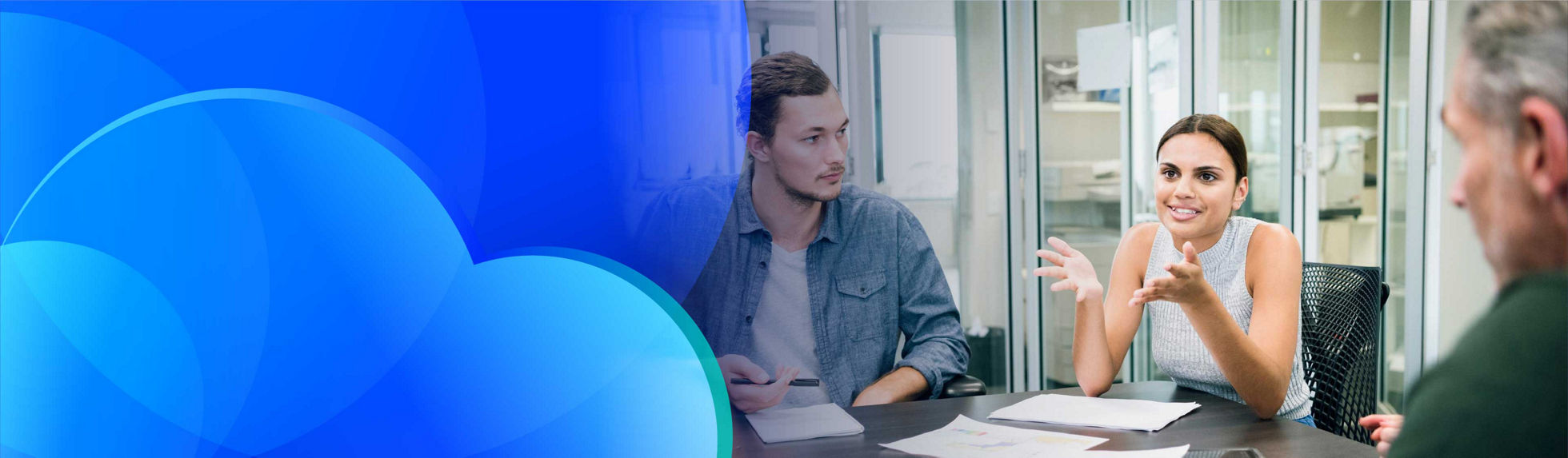 A team of professionals in discussion around a table in an office.