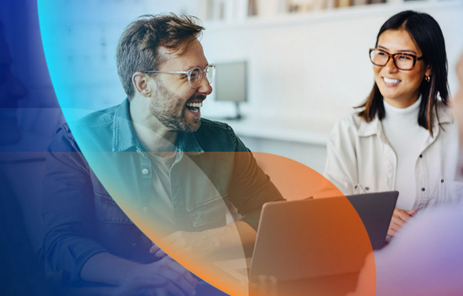 Man and woman in meeting room smiling