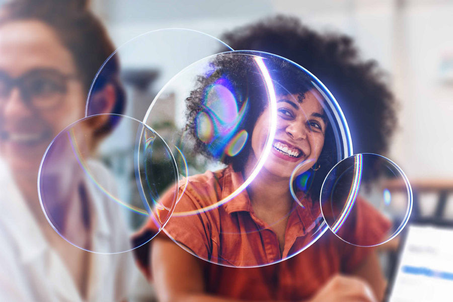 Photograph of two smiling women with transparent circular lens overlay