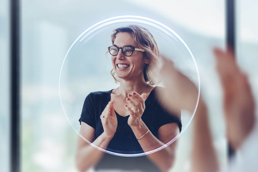 A woman smiling and clapping her hands