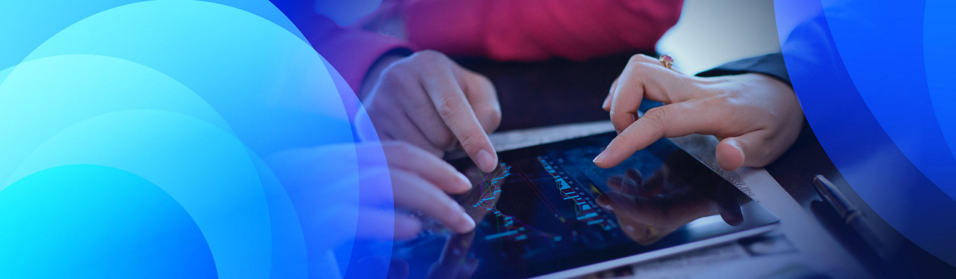 Three people interacting with graphs on a tablet