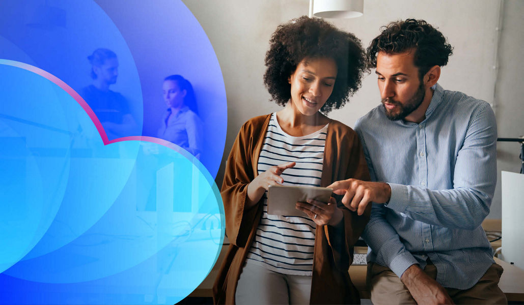 Two people talking about an app on a tablet