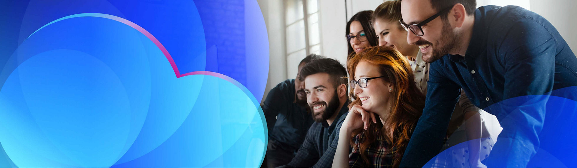 A group of cloud team members looking at a computer