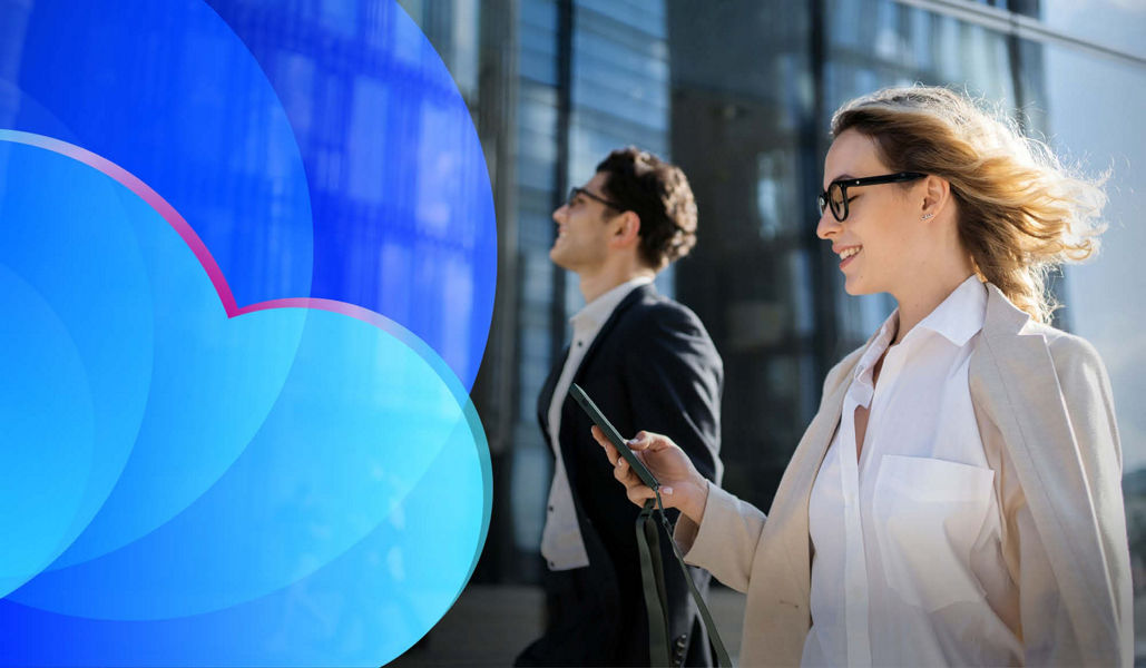 A businesswoman walking while looking at her phone