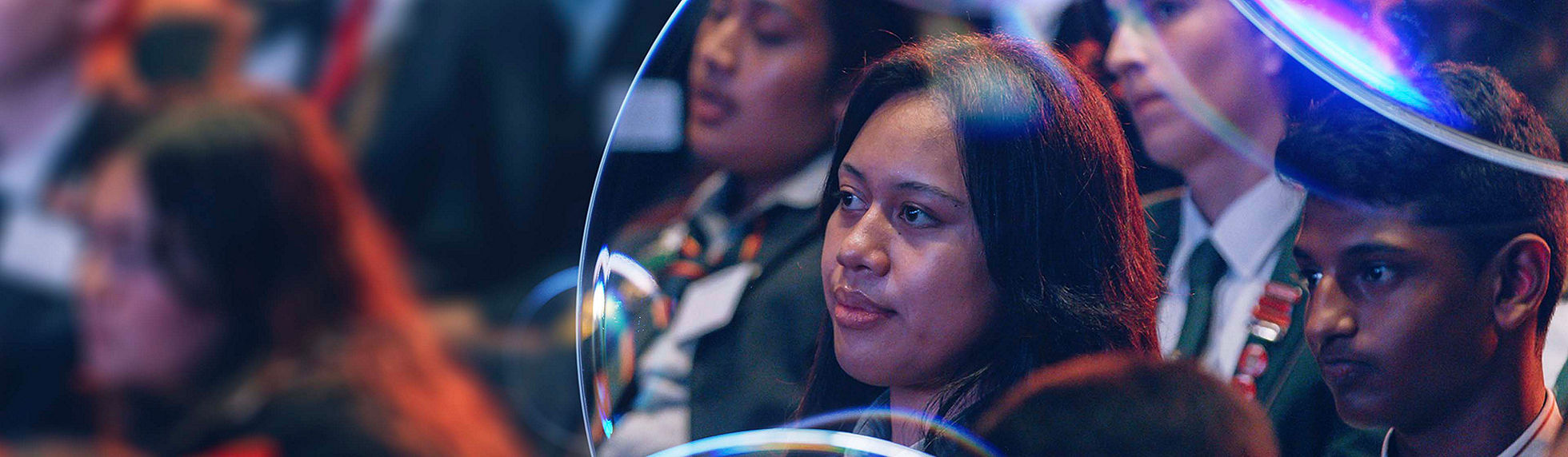 A young woman in a crowd viewed through the Datacom lens