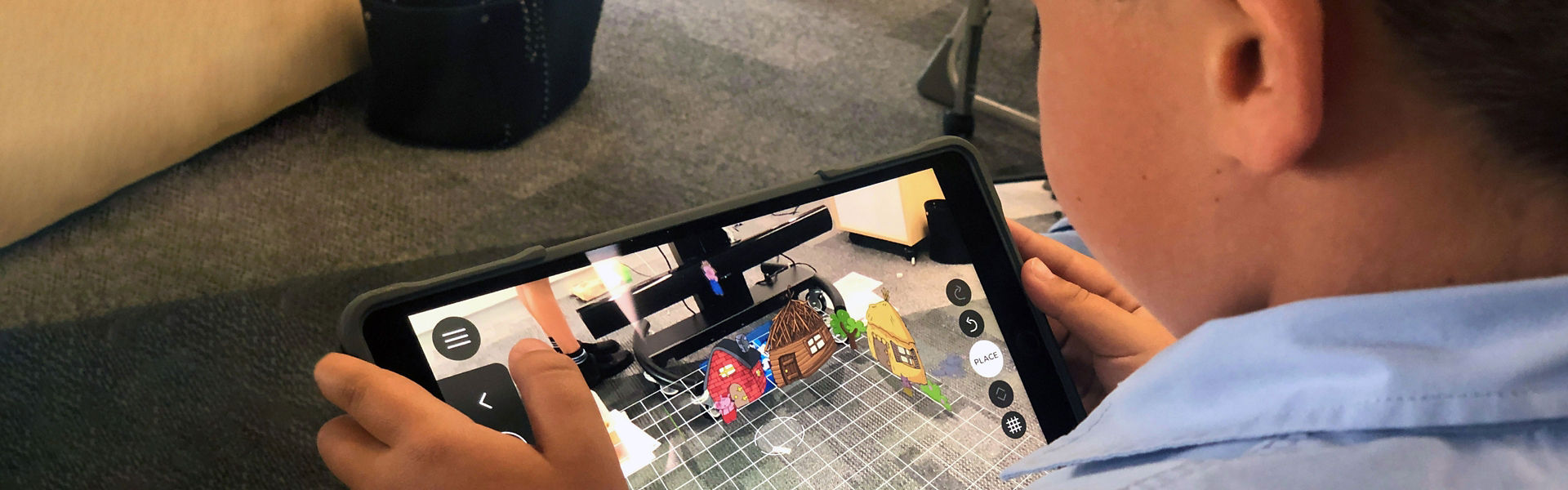 A child at school using an Apple iPad to learn