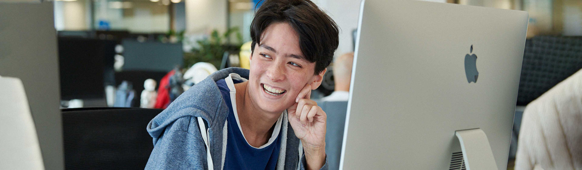 A person using an Apple iMac