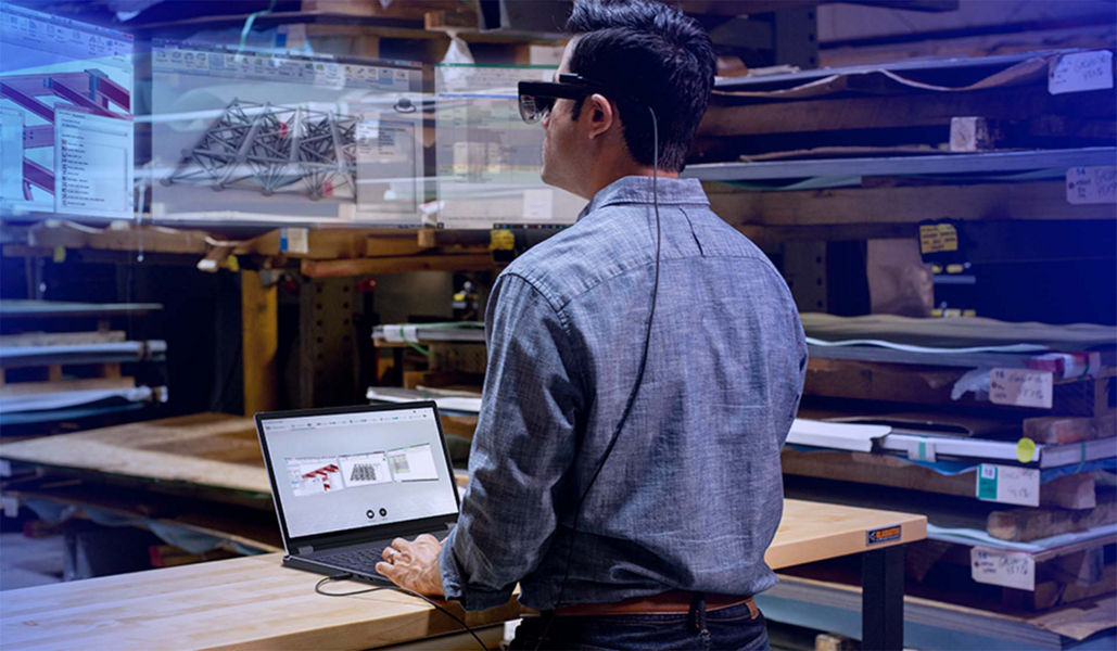 Man using VR glasses connected to a laptop to view 3D models