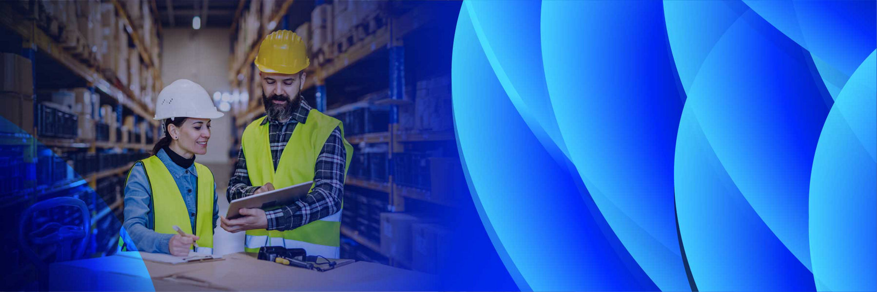 A man and woman reviewing an asset checklist in a warehouse