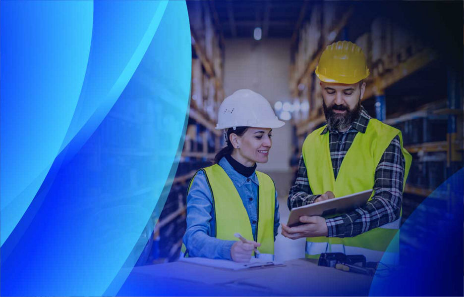 A man and woman reviewing an asset checklist in a warehouse