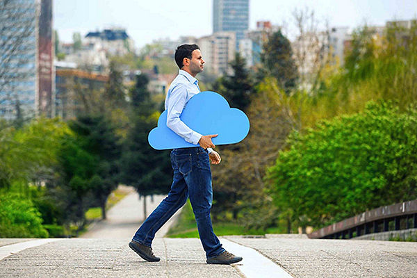 Man walking holding blue cloud