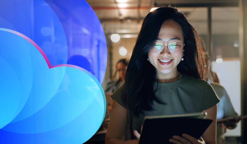 Woman looking at tablet smiling