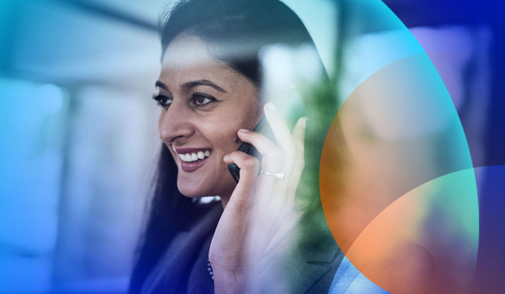 A woman talking on the phone in a data warehouse