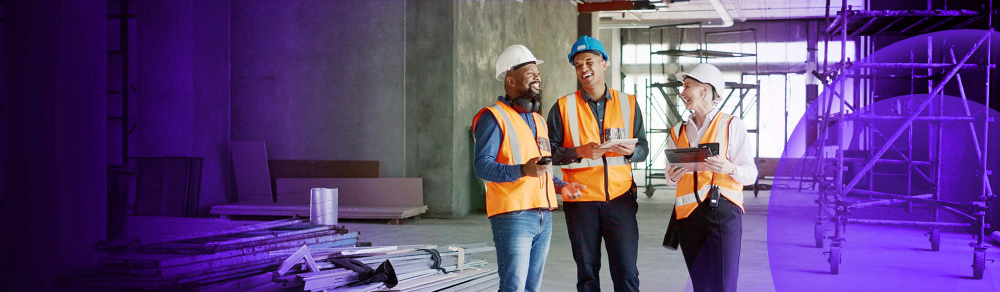 A group of people discussing consent documents on a building site