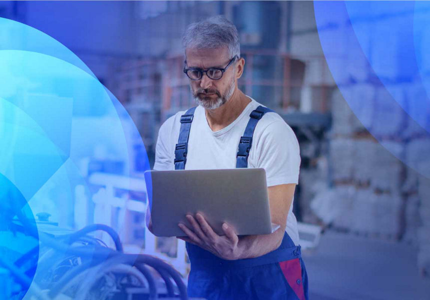 A middle aged engineer in overalls running digital tests on machinery