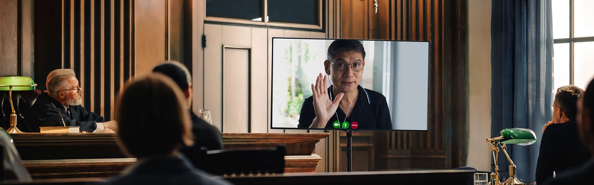 Photograph of a person addressing a court room via video call.
