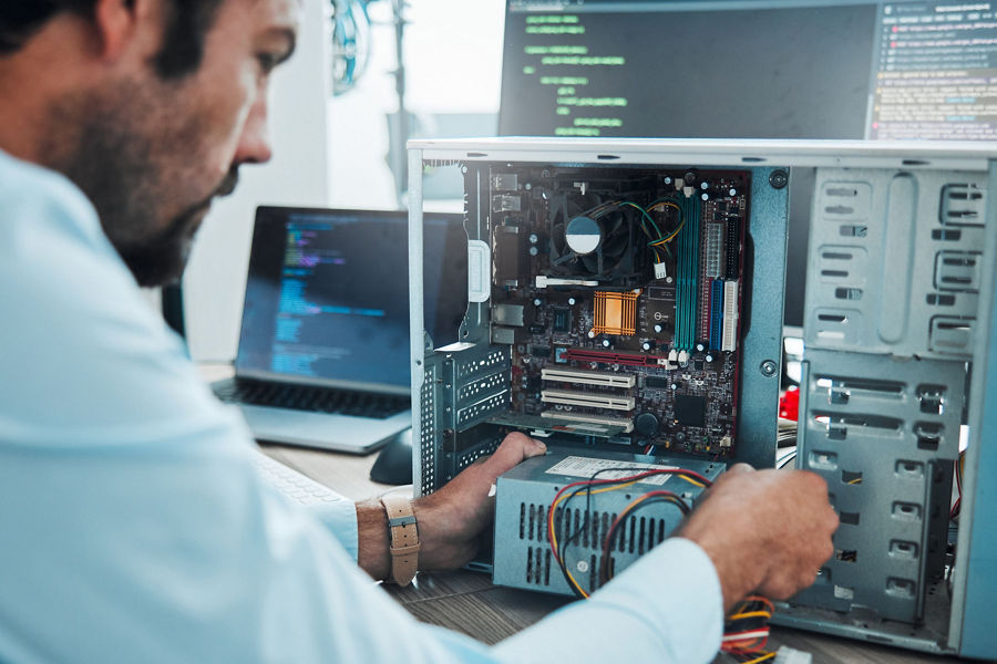 Man looking inside open harddrive
