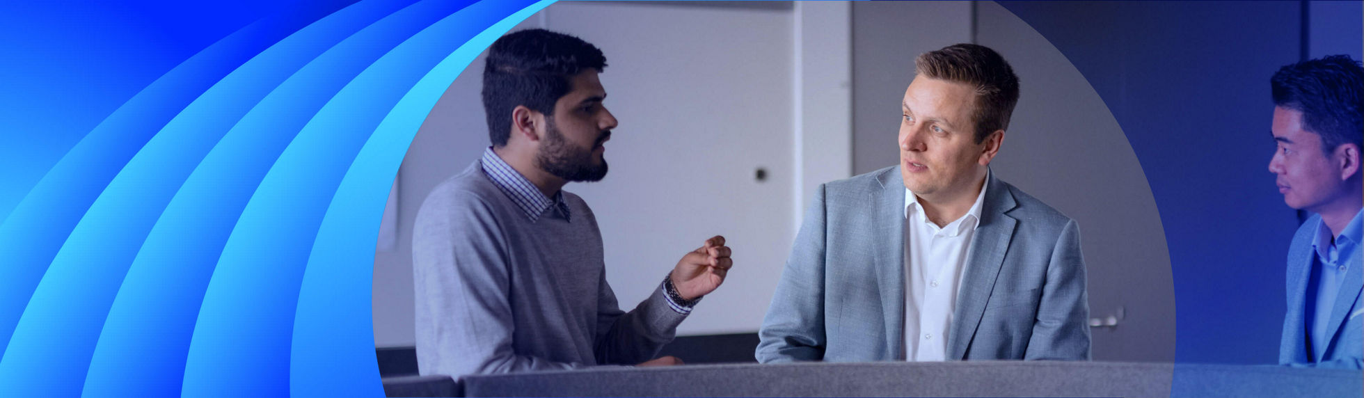 Three businessmen having a discussion in front of a whiteboard