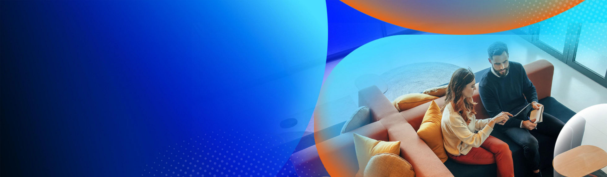Two people sitting on a couch in a corporate setting with windows behind them with an orange and blue lens overlay