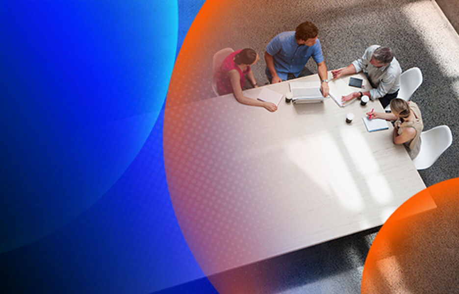 A group of people sitting at table discussing something while taking notes on paper and laptop from a birds eye view with an orange and blue lens overlay