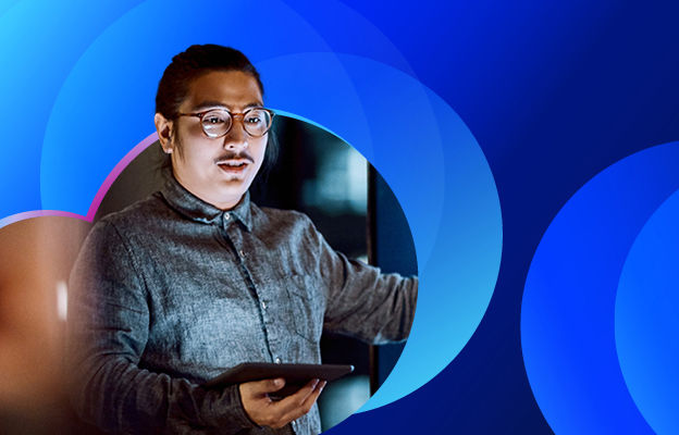 A man holding a tablet looking straight ahead