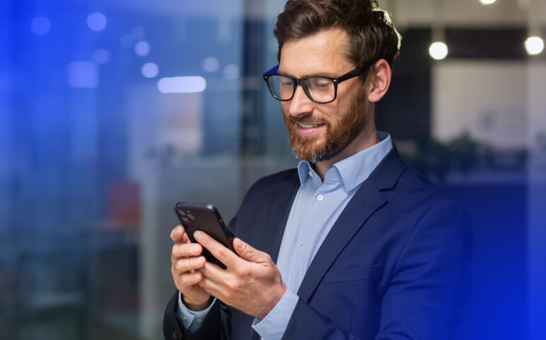 Man wearing glasses sitting at desk using a computer