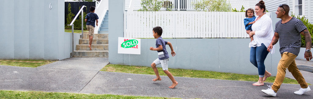kiwi family walking into their new home