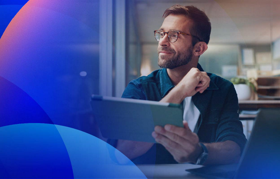 Professional holding a tablet and looking into the distance thinking about customer data.