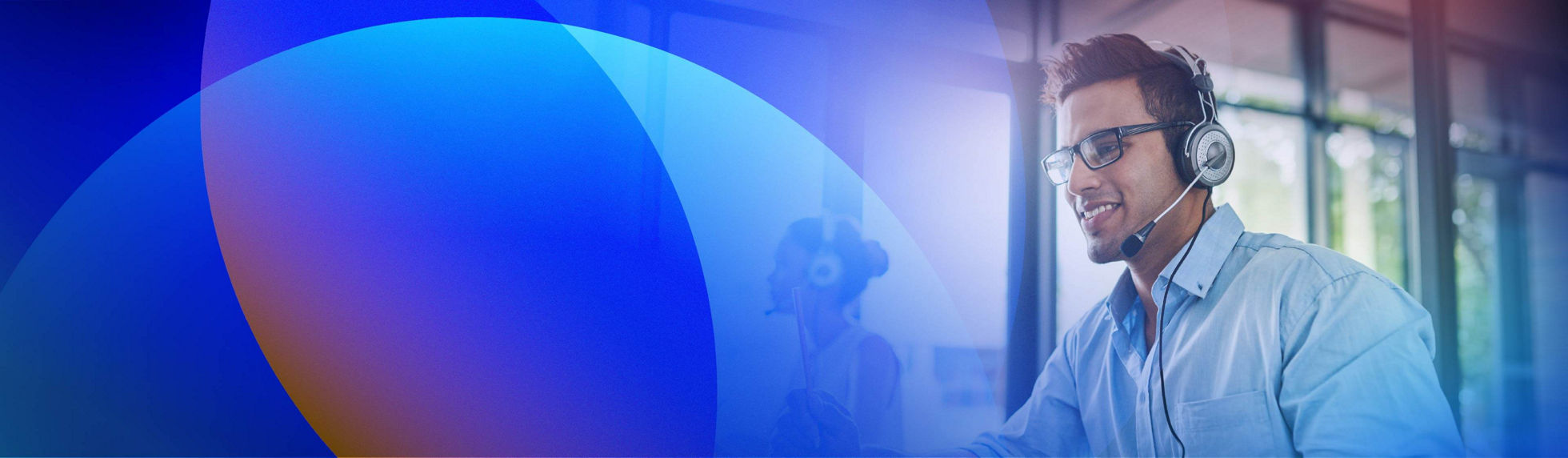 Customer service contact centre agent assisting customers in a modern office environment.