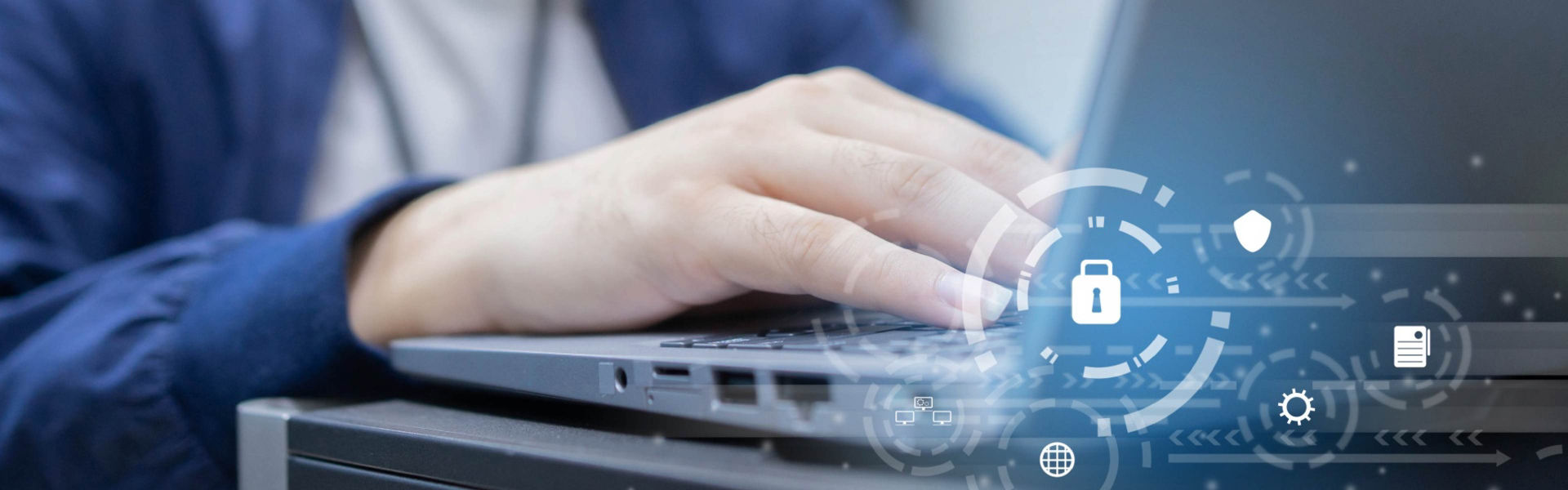Hands typing on a laptop with digital security icons overlaid, representing cybersecurity and data protection.