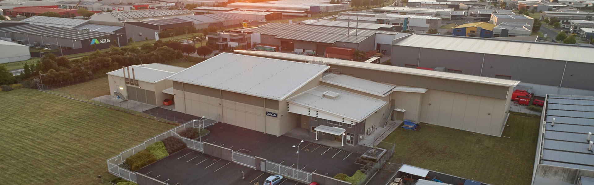 Aerial view of the Datacom Hamilton Kapua data centre at sunset on a clear evening.
