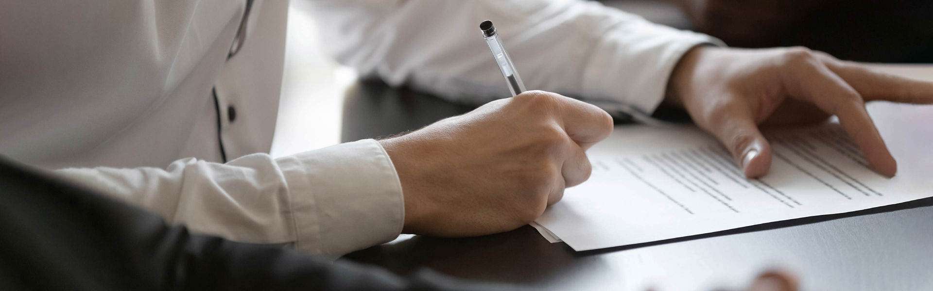 A group of people signing a document