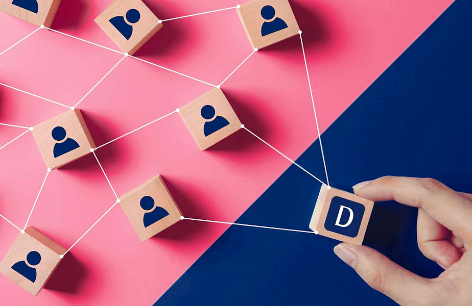 A hand holding a block and various blocks with people icons on them