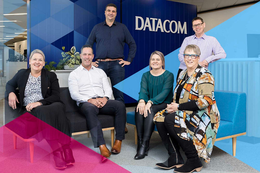 Smiling Datacom people in the Hamilton office