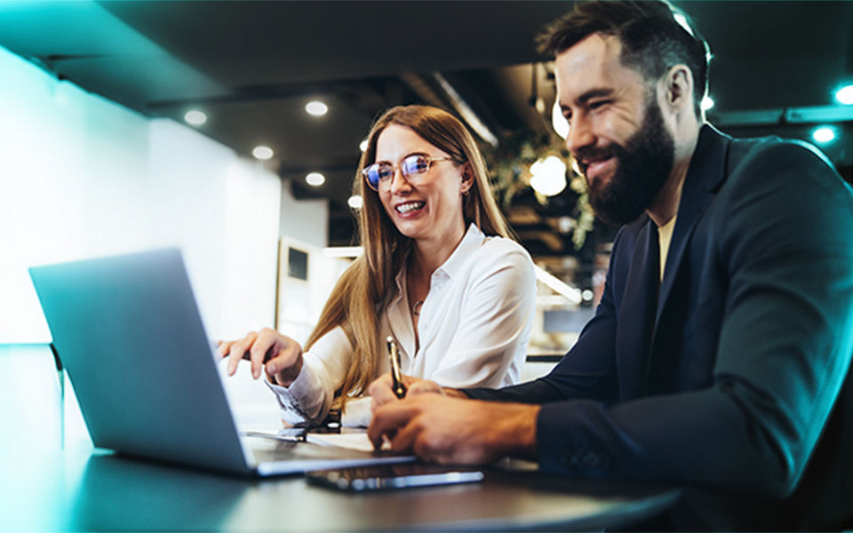 Woman and man looking at laptop