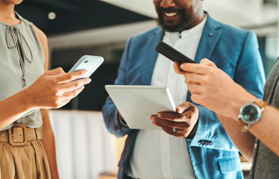 People using various devices in a group