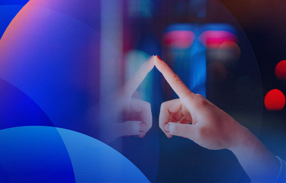 A hand interacting with a digital sign against a background of colourful blurred lights.