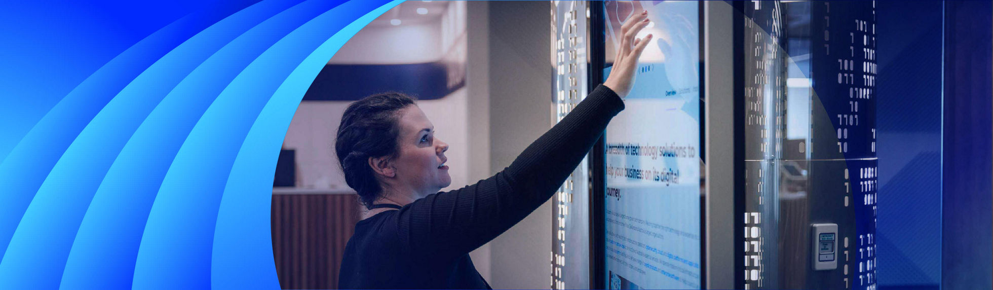 A young woman scrolling through a website on a large tablet kiosk