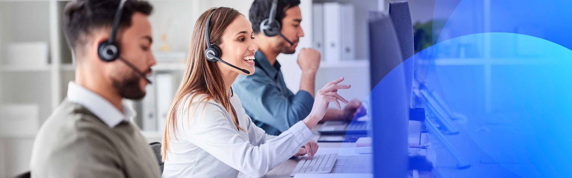 Customer service representatives assisting clients in a modern office