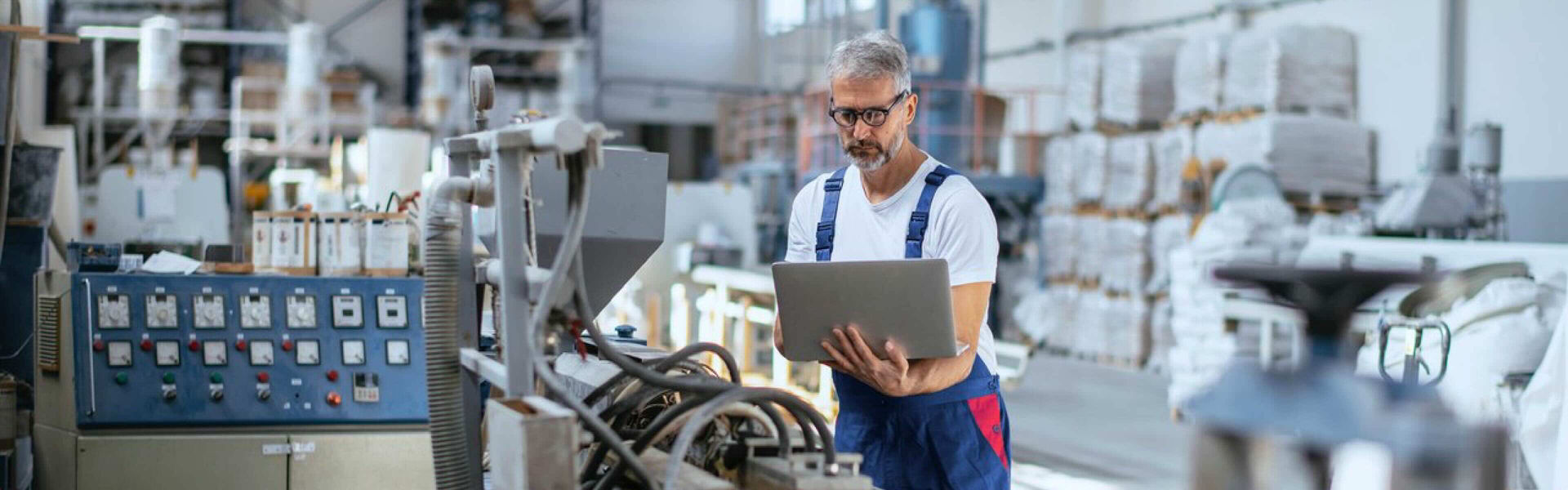 A man in an industrial warehouse packing orders