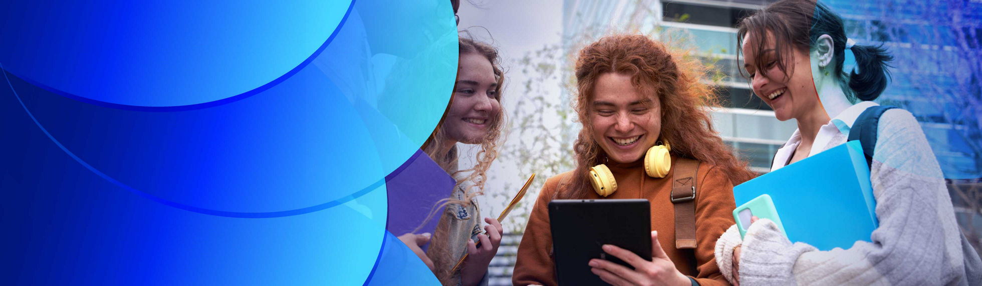 Group of cheerful students sharing an digital tablet to check the internet