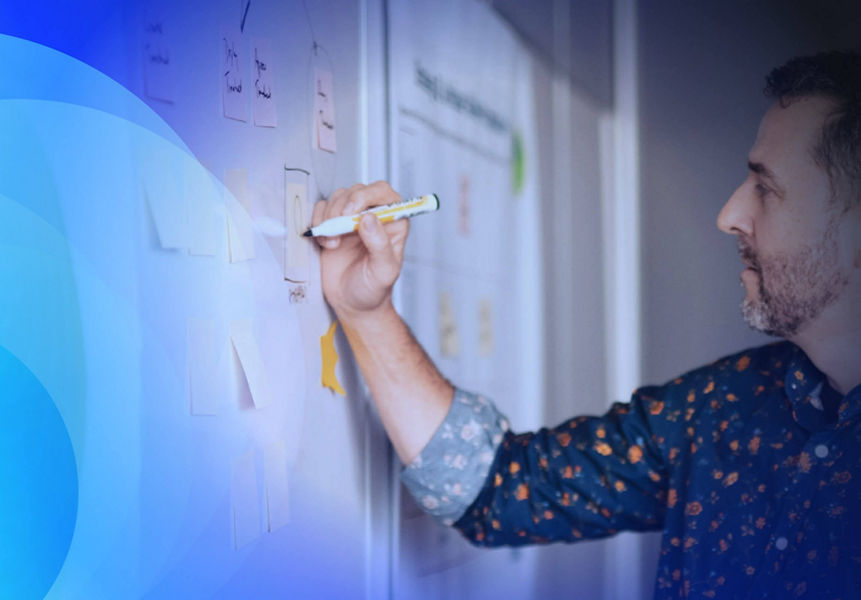 A business architect writing on a whiteboard