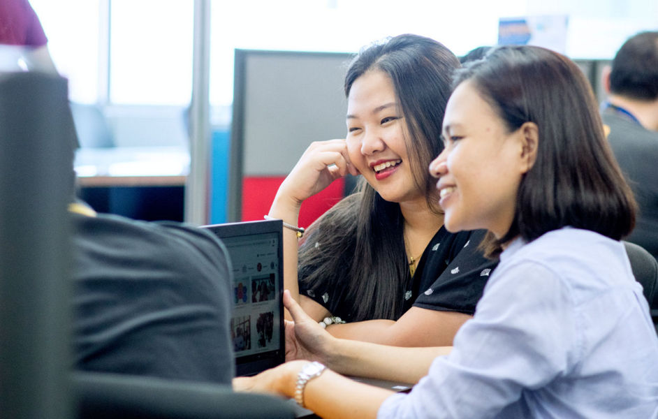 Two Datacom employees joking around during a meeting