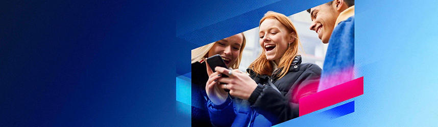 Two young girls smiling looking at a phone