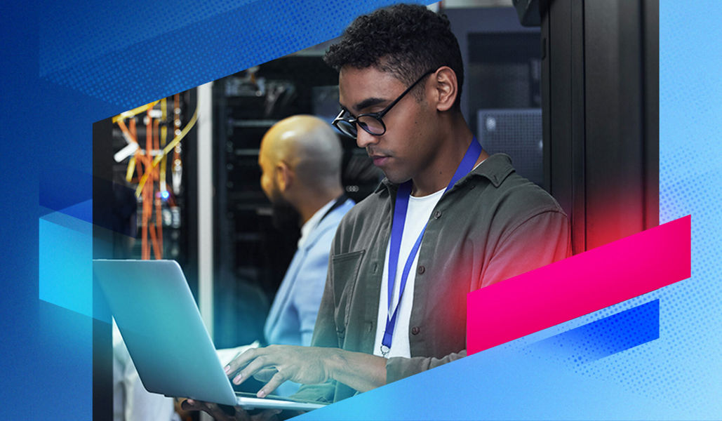 Man with laptop in a server room