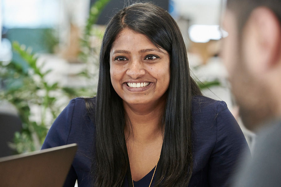 Smiling Datacom cloud services professional speaks with clients