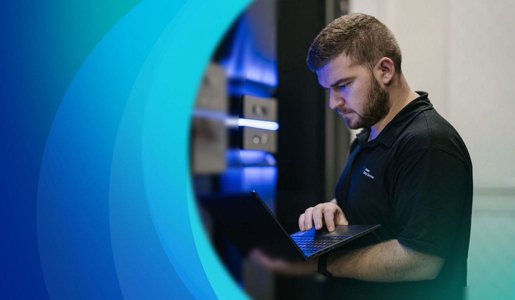 Man in racks in data centre